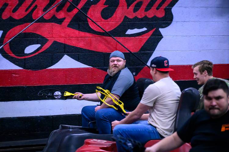 Dudes playing whirly ball.